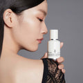 HUXLEY Biosys 360 Cream held by a woman showcasing skincare product