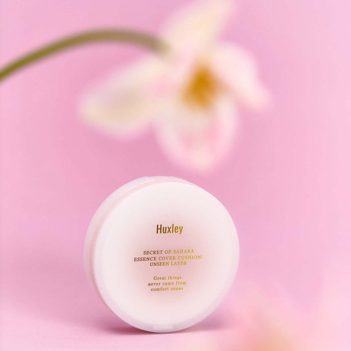 HUXLEY Essence Cover Cushion Unseen Layer with flower background, enhancing natural beauty and moisturization.