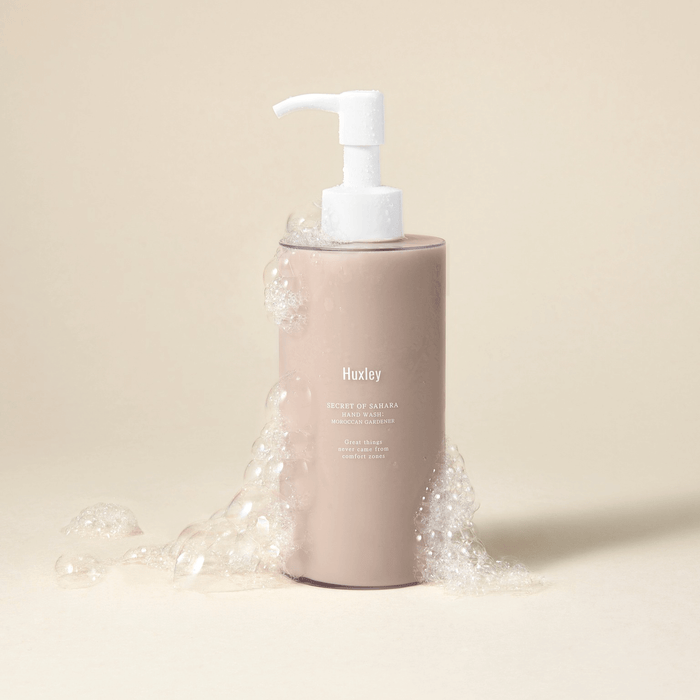 HUXLEY Hand Wash Moroccan Gardener bottle with bubbles on a neutral background.