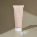 HUXLEY Intense Moisture Treatment Moroccan Gardener tube with cream swatch on brown background