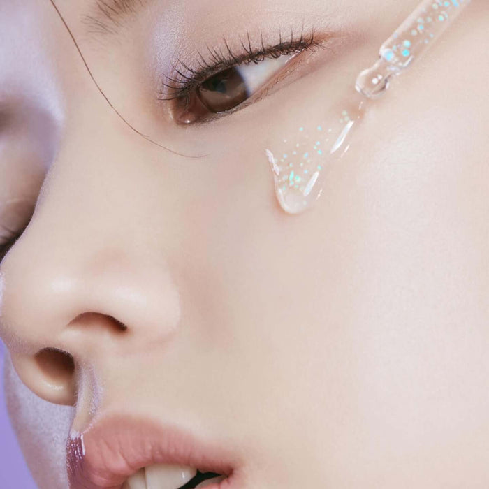 Close-up application of HUXLEY Priming Essence Rediance Layer on skin for enhanced radiance and hydration.