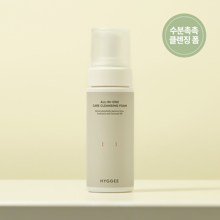 HYGGEE All-In-One Care Cleansing Foam 150ml bottle on a beige background.