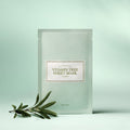 I'M FROM Vitamin Tree Sheet Mask displayed with greenery on a light green background.