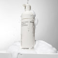 INNISFREE Apple Seed Bubble Cleanser 150ml foaming bottle with lather on a white background.