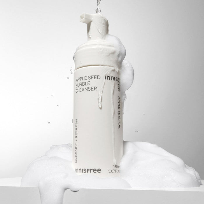 INNISFREE Apple Seed Bubble Cleanser 150ml foaming bottle with lather on a white background.