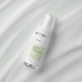 iUNIK Centella Bubble Cleansing Foam 150ml bottle on marble surface