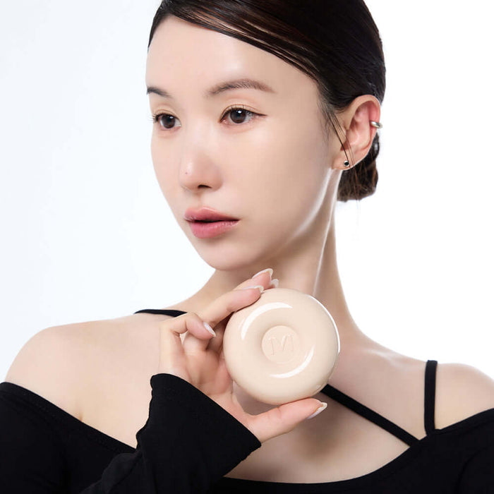 Person holding IVI MAD PEACH Plain Velvet Matte Cushion, showcasing its matte finish and design.