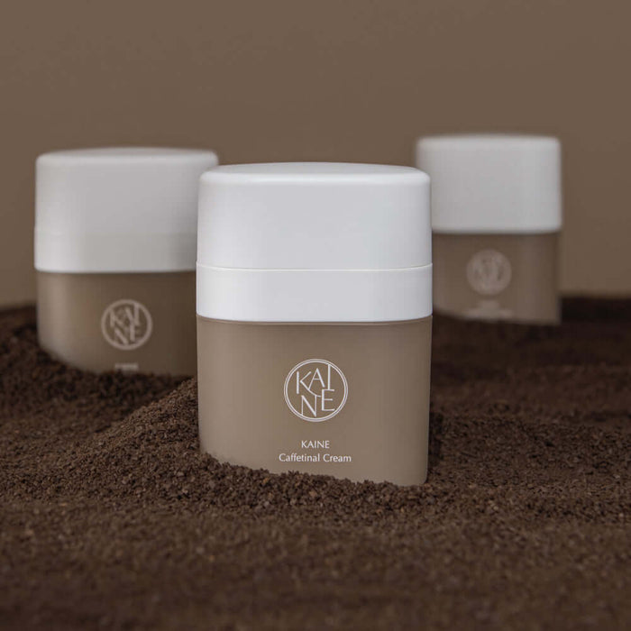 KAINE Caffetinal Cream 50ml jars displayed on a textured surface