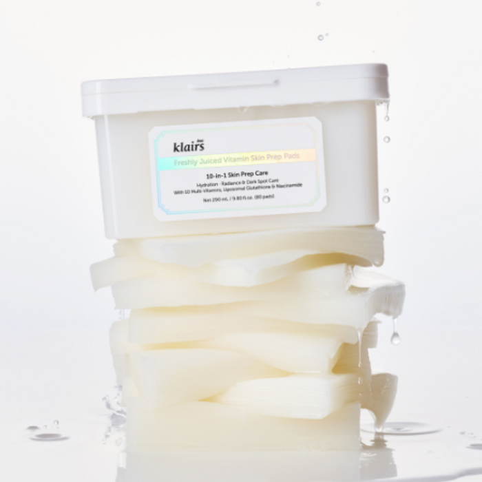 KLAIRS Freshly Juiced Vitamin Hwajalmeok Pad 80 sheets displayed with stacked, moist skincare pads on a white background.