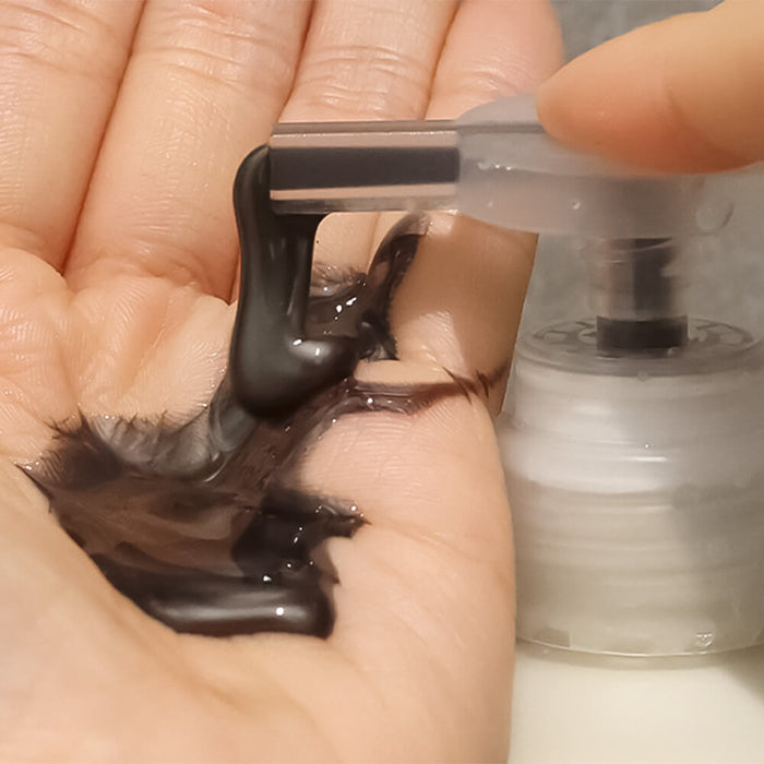 Applying LADOR ASH Silver Shampoo 300ml in hand, showcasing texture and color of the product
