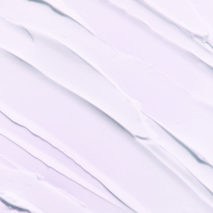 Texture of LADOR Volumizing Curl Cream 80ml spread on a surface, showcasing its smooth and creamy consistency.