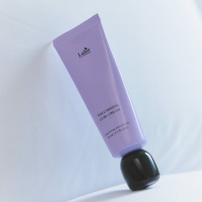 LADOR Volumizing Curl Cream 80ml in a purple tube on a white background.