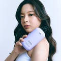 Woman holding LADOR Volumizing Curl Shampoo 530ml bottle.