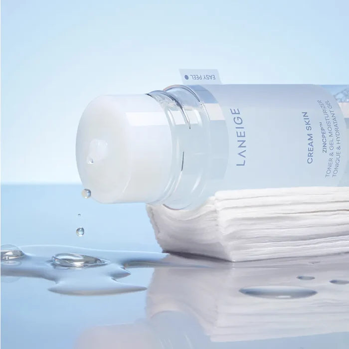 LANEIGE NEW Gel Cream Skin 170ml bottle with drops, showcasing its hydrating texture on a stack of cotton pads, perfect for skincare.