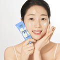 Woman applying MAMONDE Calming Shot Azulene Sun Cream SPF50+PA++++ 35ml with glowing skin