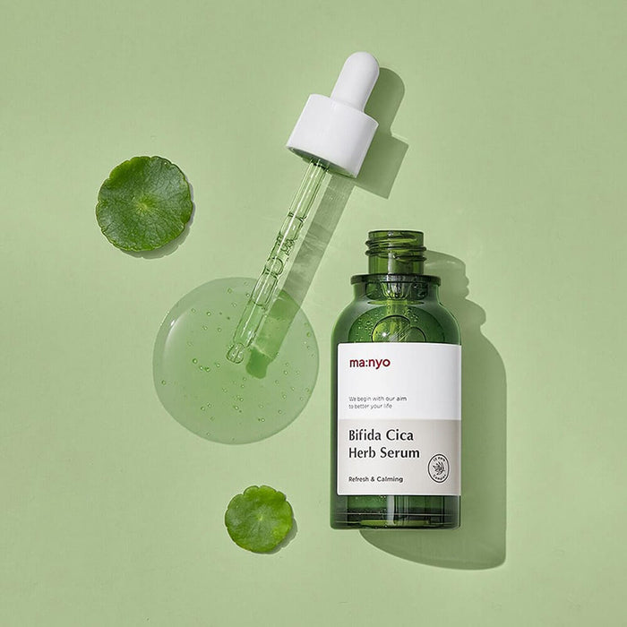 MANYO Bifida Cica Herb Serum 50ml bottle with dropper on green background showcasing skincare product.
