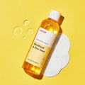MANYO Blackhead & Pore Toner 210ml bottle on yellow background with cleansing pads