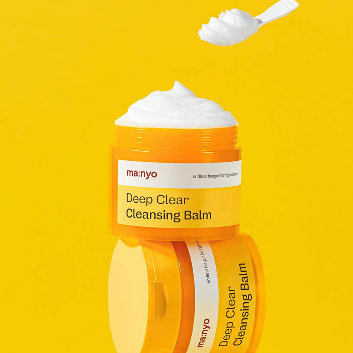 MANYO Deep Clear Cleansing Balm 132ml in vibrant yellow container with smooth balm texture, featured on a yellow background.