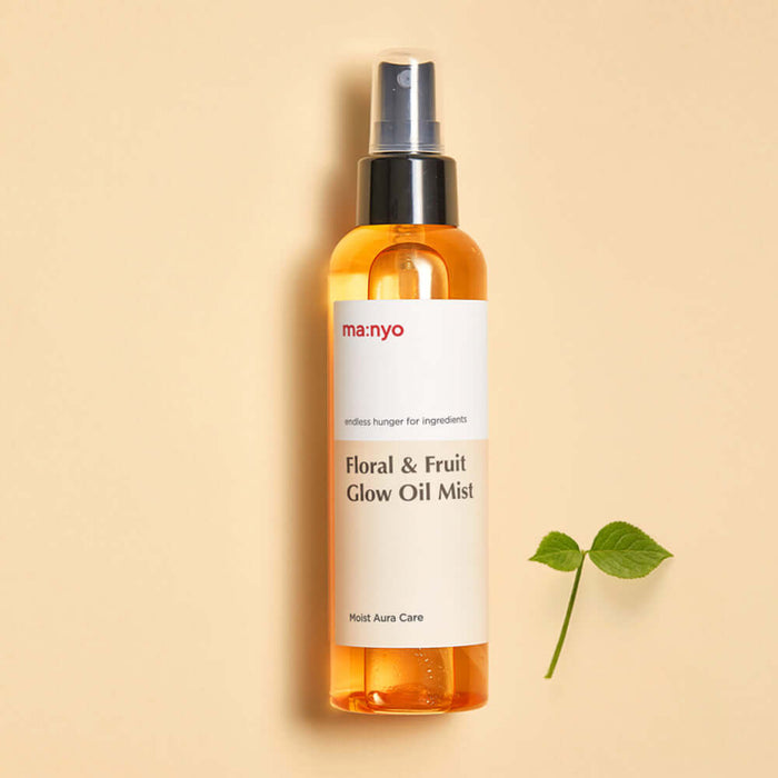 MANYO Floral & Fruit Glow Oil Mist 150ml bottle on neutral background with leaf accent