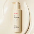 MANYO Pure Soybean Cleansing Milk 200ml bottle displayed on a sleek surface for gentle and hydrating skincare.