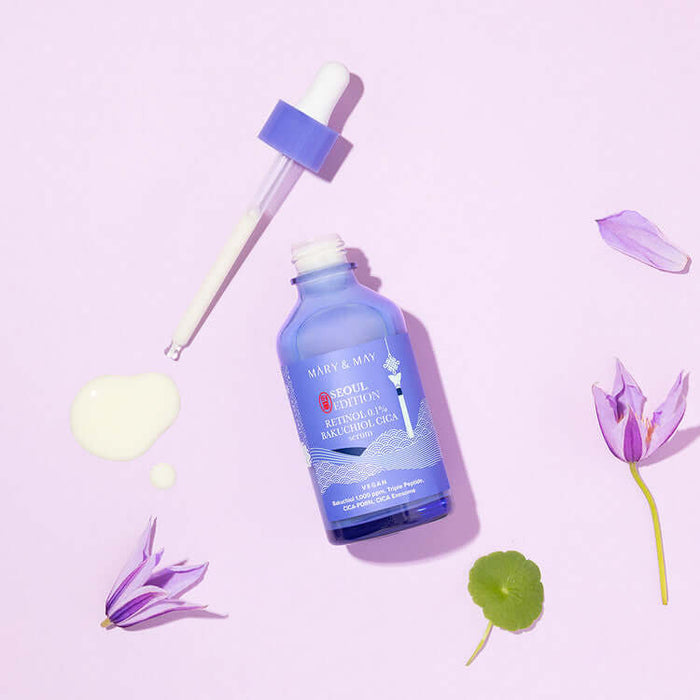 MARY & MAY Retinol 0.1% Bakuchiol Cica Serum 80ml bottle with dropper on a pink background and flower accents.