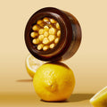 Open jar of MEDICUBE Deep Vita C Capsule Cream 55g with lemons in the background, showcasing skincare product ingredients.