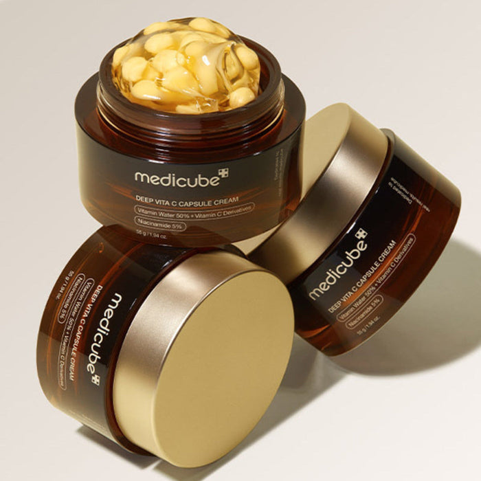 MEDICUBE Deep Vita C Capsule Cream 55g skincare product in brown and gold jar with visible capsule cream texture