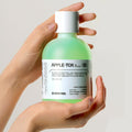 Hands holding MEDIPEEL Dr.Apple Tox Pore Toner 500ml bottle