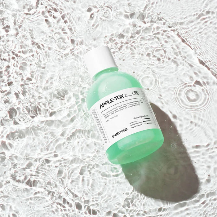 MEDIPEEL Dr.Apple Tox Pore Toner 500ml bottle on rippled water surface