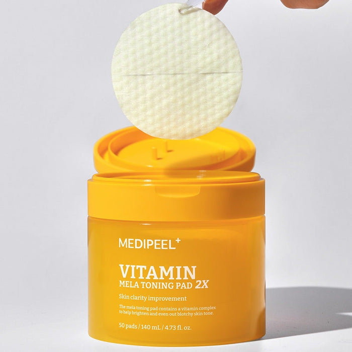 MEDIPEEL Vitamin Mela Toning Pads 2X 140ml 50sheets in yellow packaging with a pad being lifted out of the container.