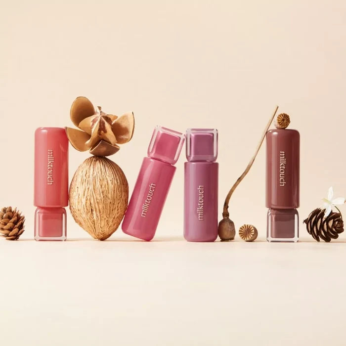 MILK TOUCH Jelly Fit Tinted Glow Tint products displayed with natural elements like pinecones and dried flowers.