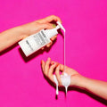 Hands pouring MISE EN SCENE Innerplex Hair Strengthening Shampoo 375g against pink background