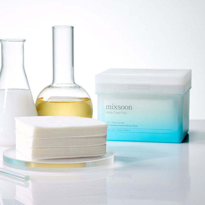MIXSOON Bifida Toner Pad next to laboratory glassware for skincare routine