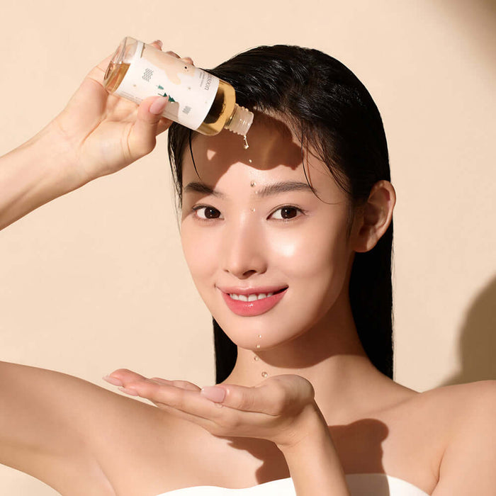 Woman applying MIXSOON Soondy Centella Asiatica Essence 100ml to face, highlighting skincare routine