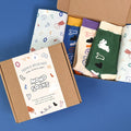 Colorful socks in a box with playful patterns, labeled as MONOLIKE Olly Molly - Initial Set.