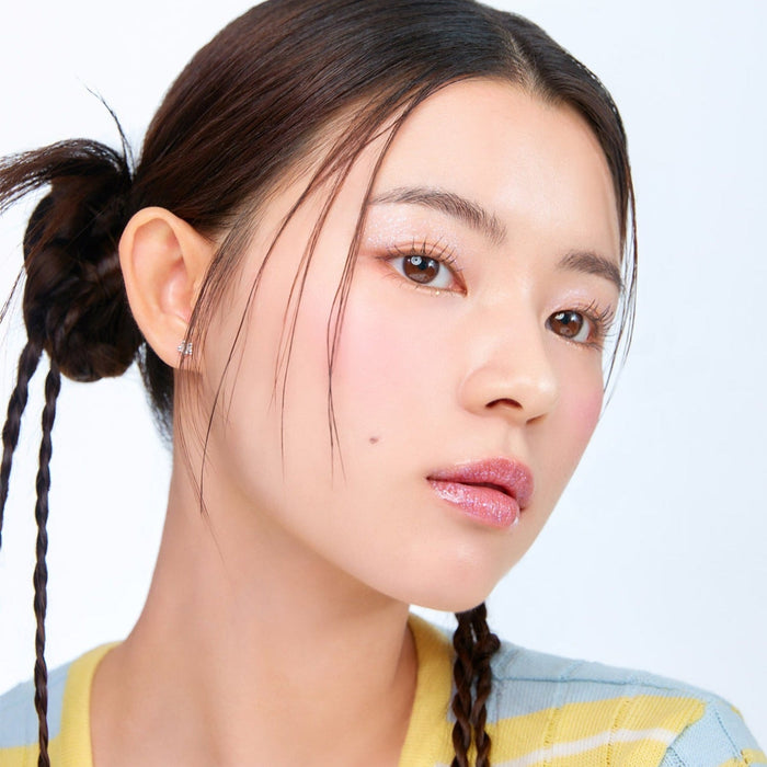 Model showcasing MOONSHOT Melting Mood Lip & Cheek in natural light, highlighting smooth texture and vibrant color on lips and cheeks.
