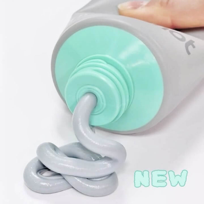 MOONSHOT Micro Black Cleansing Foam being dispensed from a light grey tube. Suitable for deep cleansing and skincare. New product.
