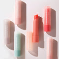 NATURE REPUBLIC Essentail Lip Balm collection showcasing various shades and packaging on a light background.
