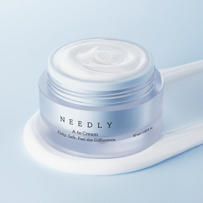 NEEDLY A to Cream 50ml moisturizing jar on blue background