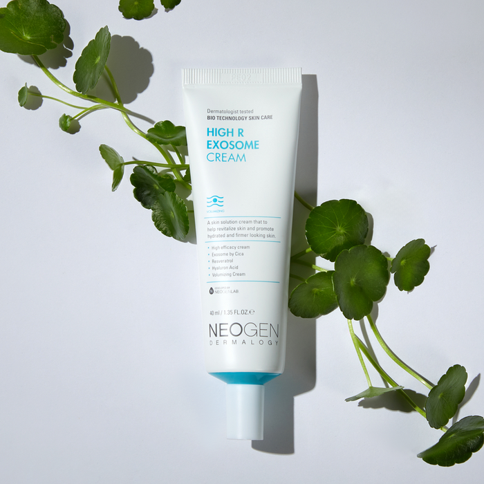 Image of NEOGEN Hyal Exosome Cream 40ml tube with green leaves on white background for skincare.