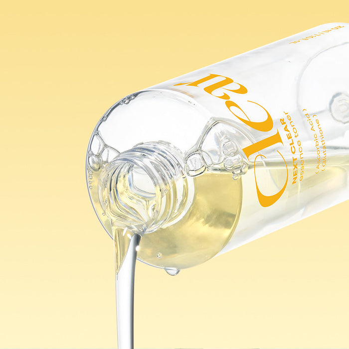 NEOGEN Next Clear Essence Toner 210ml bottle pouring liquid against yellow background