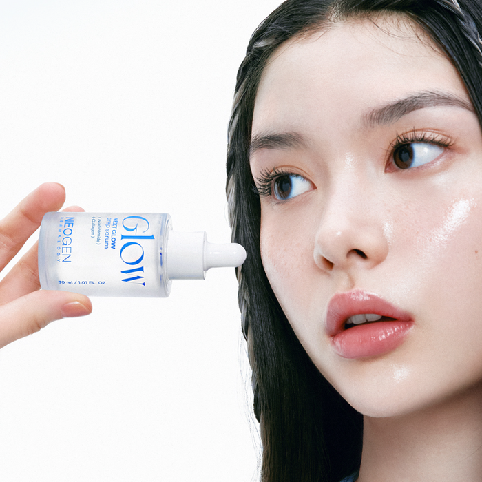 Woman applying NEOGEN Next Glow Prep Serum 32ml to face, highlighting radiant skin benefits.