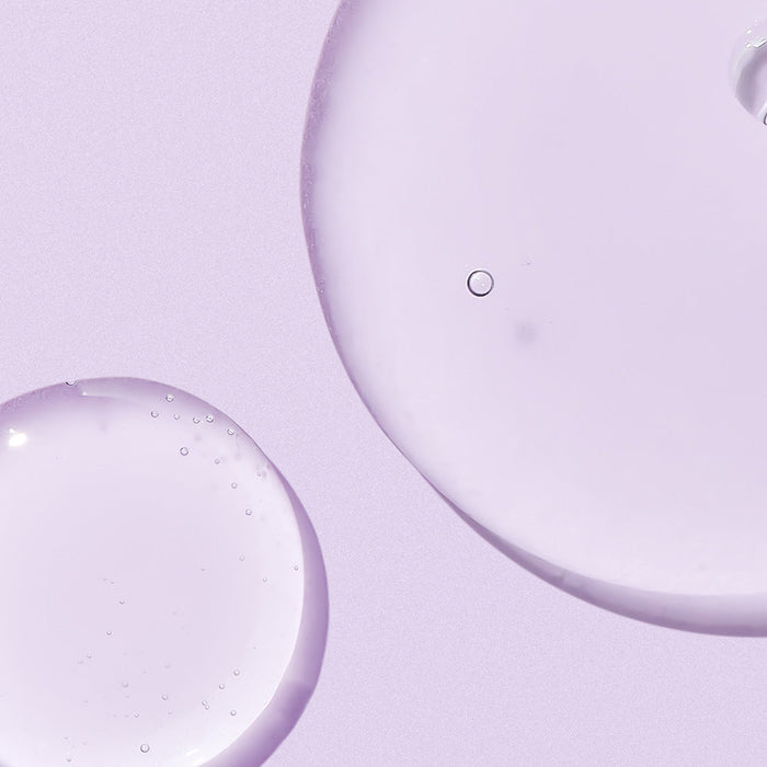 Texture of NEOGEN Real Bakuchiol Firming Serum 30ml on a lavender background
