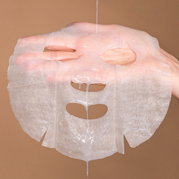 NEOGEN Real Heartleaf Soothing Mask 5 Packs being shown by hand to display its texture and quality.