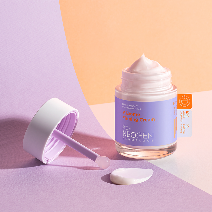Jar of NEOGEN V Biome Firming Cream 60g on a pastel background with cream texture and spatula.