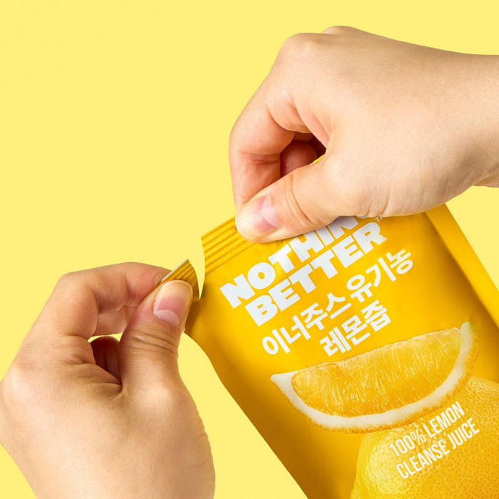 Woman opening a packet of NOTHING BETTER Inner Juice 100% Lemon Cleanse Juice 100ml (X24), showcasing vibrant lemon graphics on yellow packaging.