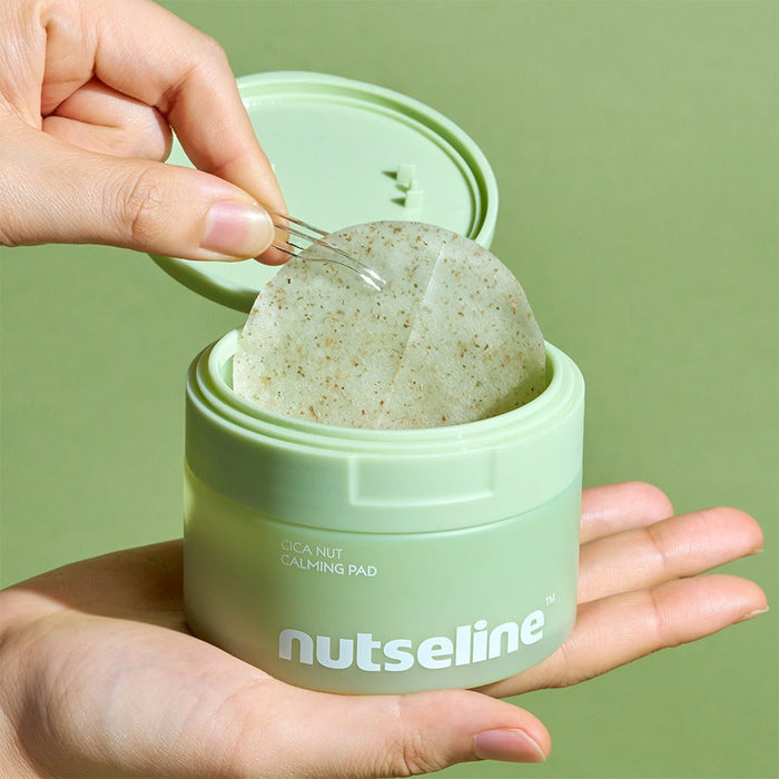 Person holding a NUTSELINE Cica Calming Pad container with open lid and visible calming pad inside.