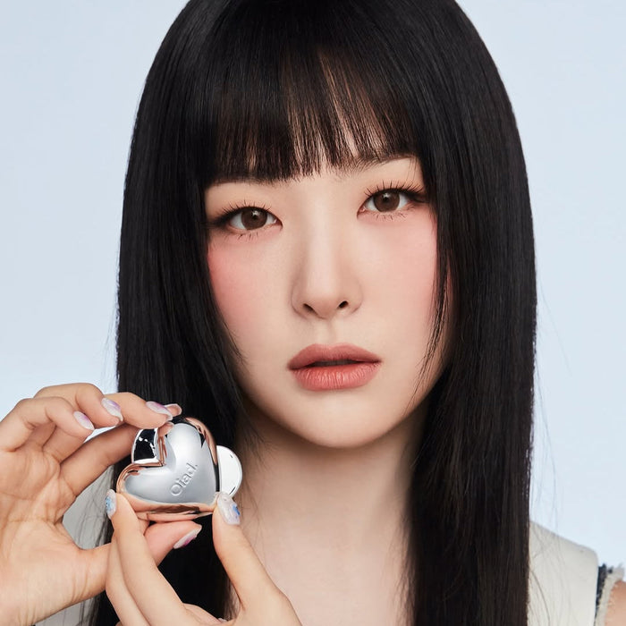 Model holding OIAD Silverpulse Moussecream Lip&Cheek product, showcasing dual-use lip and cheek makeup in heart-shaped packaging.