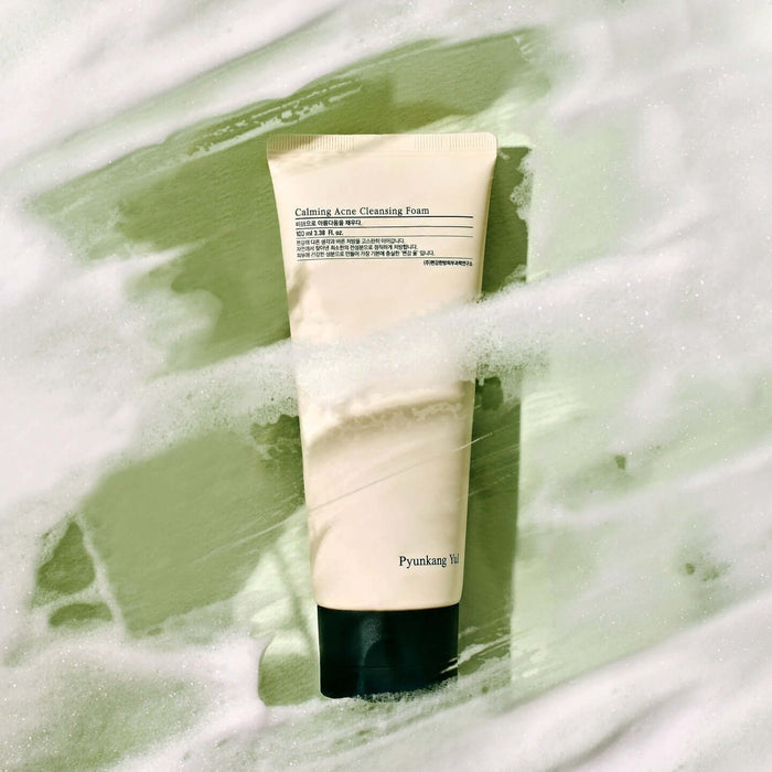 PYUNKANG YUL Calming Acne Cleansing Foam 100ml against a foamy green backdrop