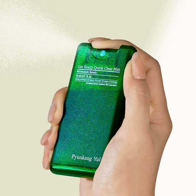 Hand holding PYUNKANG YUL Get Ready Quick Clear Mist 15ml in green bottle.